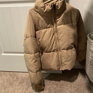 Tan puffer jacket.
